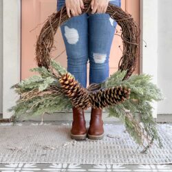 An easy pinecone grapevine wreath using a few picks of greenery, large pinecones and wood branches. Love this easy winter wreath!