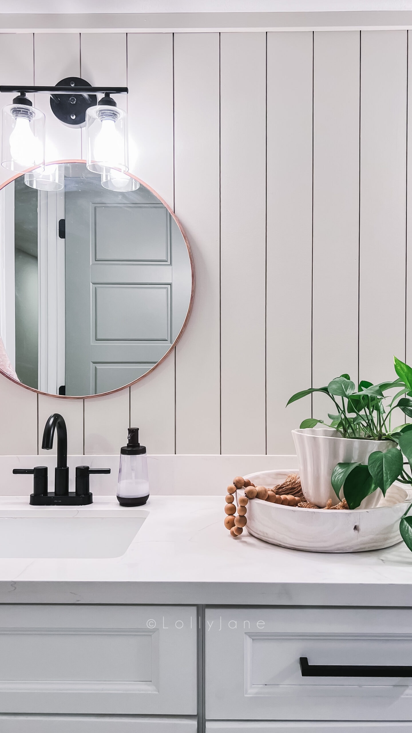 Easy tutorial for a vertical shiplap bathroom wall treatment. Love the cream shiplap in this basement bathroom makeover.